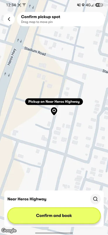 Confirming the pickup spot in the GuyWay app: a pin on the street map that you move by dragging the map, and a Confirm and book button