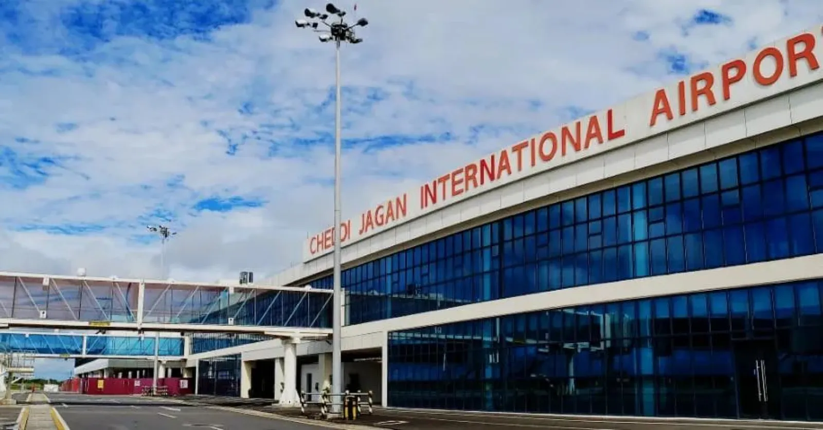 Cheddi Jagan International Airport exterior in daylight, Timehri, Guyana — the ground-transport network GuyWay is hiring to build across Georgetown and beyond