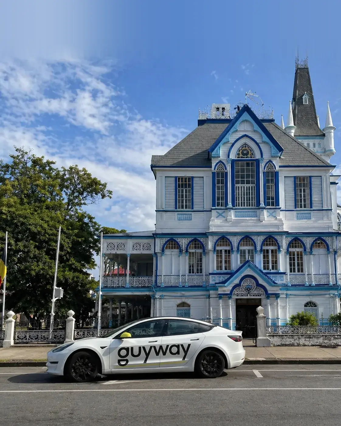 A GuyWay electric Tesla outside a Georgetown civic landmark